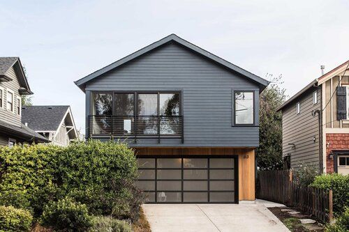 a house with two garages in front of it