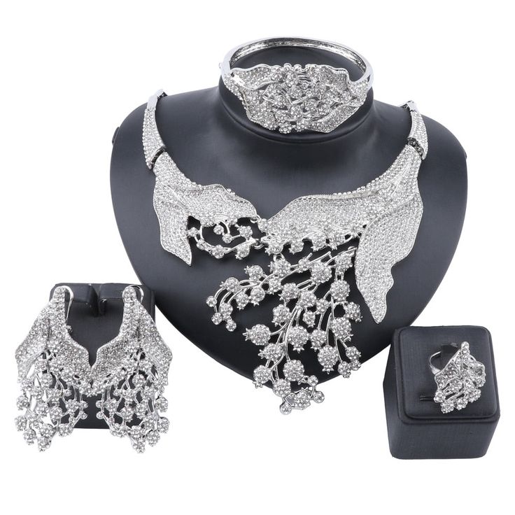 A metal platted stone upholstered jewelry set for party or wedding purposes. A shining jewelry set that attracts everyone's eye towards you enhances your beauty. the stone adds a shining effect to the jewelry. A piece is bound to get praised because of its beauty-enhancing quality. Features Material: Metal, Stone Style: Trendy Fine or Fashion: Fashion Item Type: Jewelry Sets Occasion: party Shape\pattern: Plant Jewelry Sets: gold plated What Includes 1 X Necklace set (1necklace, 1pair of earring Party Alloy Jewelry With Bling, Elegant Metal Bridal Sets For Party, Elegant Party Jewelry Sets With Stone Setting, Glamorous Rhinestone Alloy Jewelry, Glamorous Alloy Jewelry For Wedding, Glamorous Alloy Wedding Jewelry, Elegant Silver Bridal Sets With Rhinestones, Silver Rhinestone Necklace For Wedding, Silver Alloy Rhinestone Necklace For Wedding