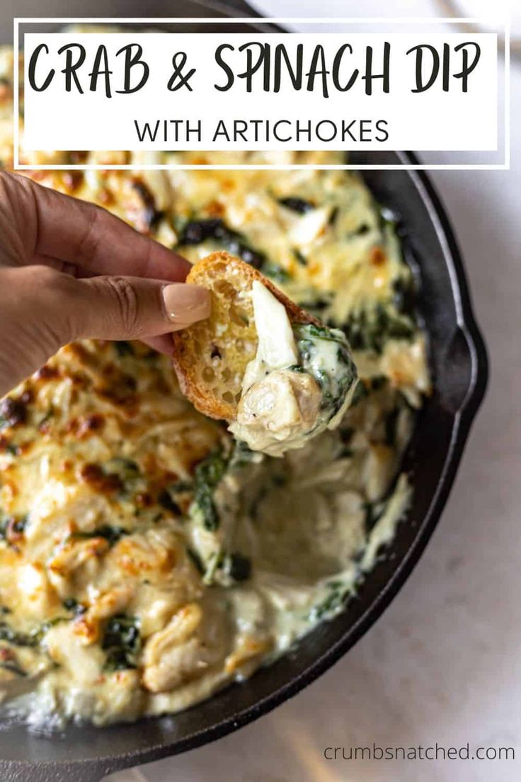 a hand holding a piece of bread with spinach dip in it and the words crab & spinach dip on top