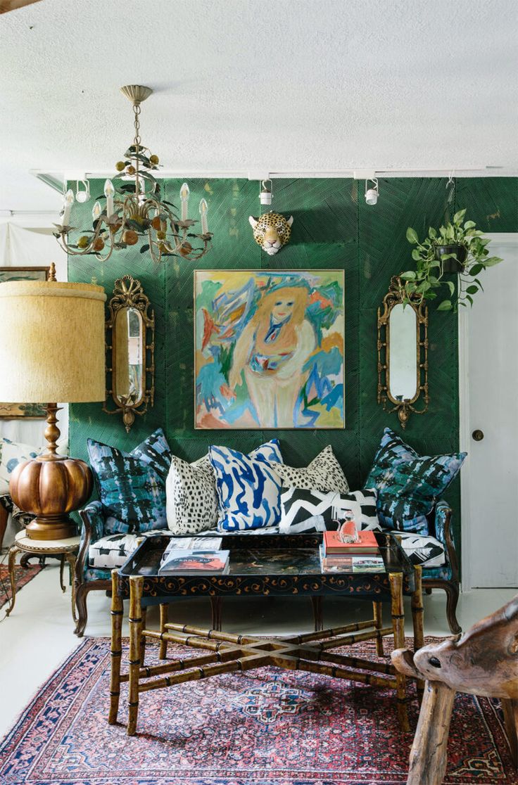 a living room filled with furniture and decor on top of a blue carpeted floor