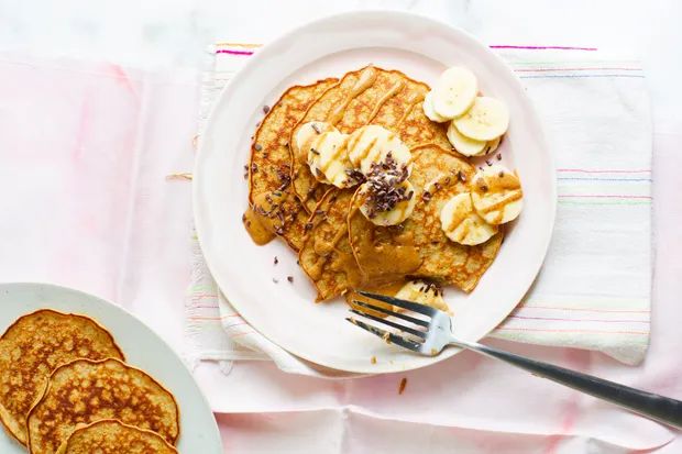 pancakes and bananas on a plate with a fork