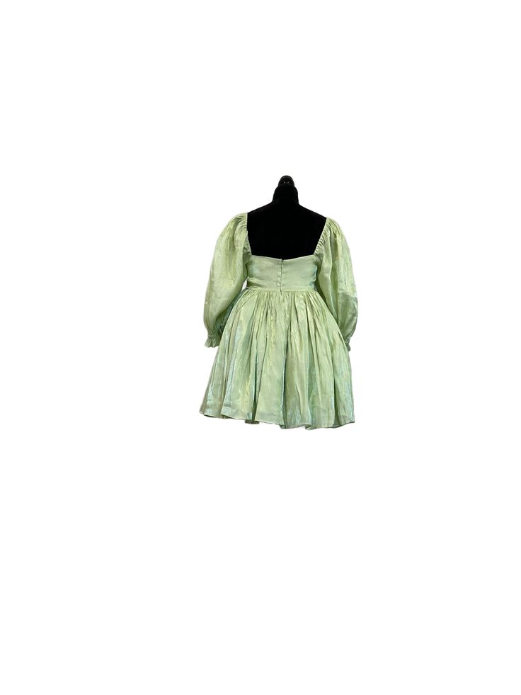 Light Green Babydoll Dress Just like the flutter and glimmer of a fairy's wings, this shimmery dress gracefully sways and bounces, bestowing you with magical essence. This babydoll dress features a luscious green satin fabric that shimmers in the light. The puffy 3/4 sleeves and bouncy skirt give movement to every step you take. The skirt of this dress is extra voluminous with three layers, while the top is double-layered for coverage. The innermost layer of this dress is sewn to hide the seams for the smoothest wear against your skin. It closes at the back with an invisible zipper. Dress is approximately 32" in length. Model is 5'2, wearing a size small. Shimmery Dress, Zipper Dress, Every Step You Take, Fairy Wings, Green Satin, Spring Green, Babydoll Dress, Invisible Zipper, Satin Fabric