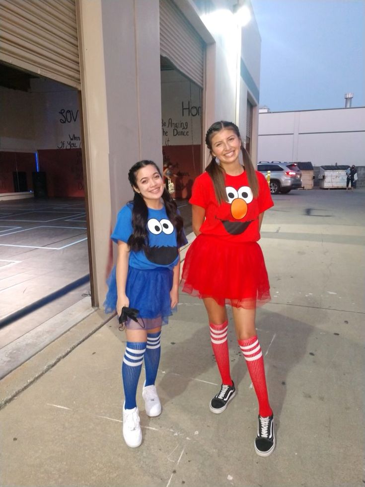 two girls in costumes standing next to each other