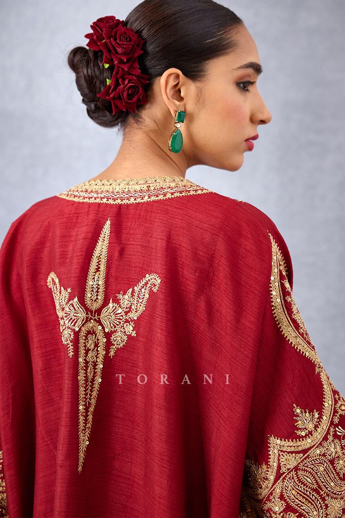 Editor's Note Featuring a bright red free styled kaftan having heavy embroidered yoke along with straight cut fit pants Color: Red Fabric: Slub silk Components: Kaftan and pants Embroidery details: Hand embroidery, dori and hand adda work Fit: Loose Occasion: Festive Care: Dry Clean Only About the Designer Torani by Karan Torani stands handcrafted luxury inspired by the myriad tales of Indian mythology. Torani is a potpourri of all things nostalgic that binds you with a memory long forgotten. Th Dori Work Embroidery Design, Kaftan And Pants, Heavy Suits, Pants Embroidery, Kaftan Set, Bandhej Print, Suits For Women Indian, Dori Embroidery, Long Kurtas