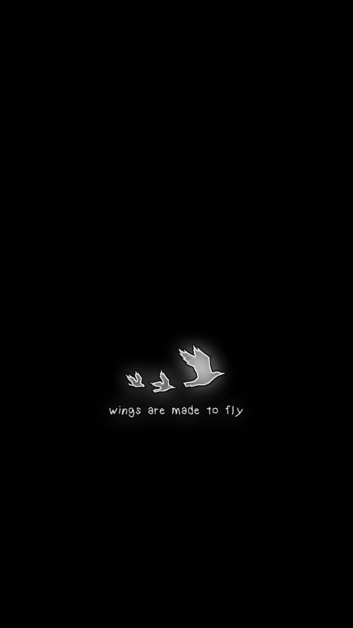 an airplane flying in the dark with white writing on it's side and black background