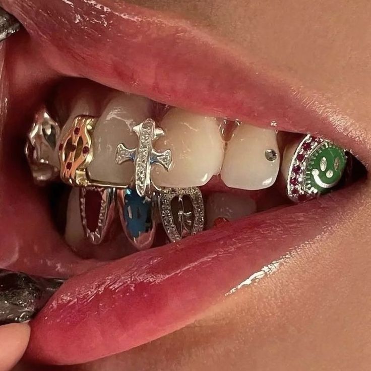 a woman's teeth are decorated with different colored and shaped rings, while the image shows