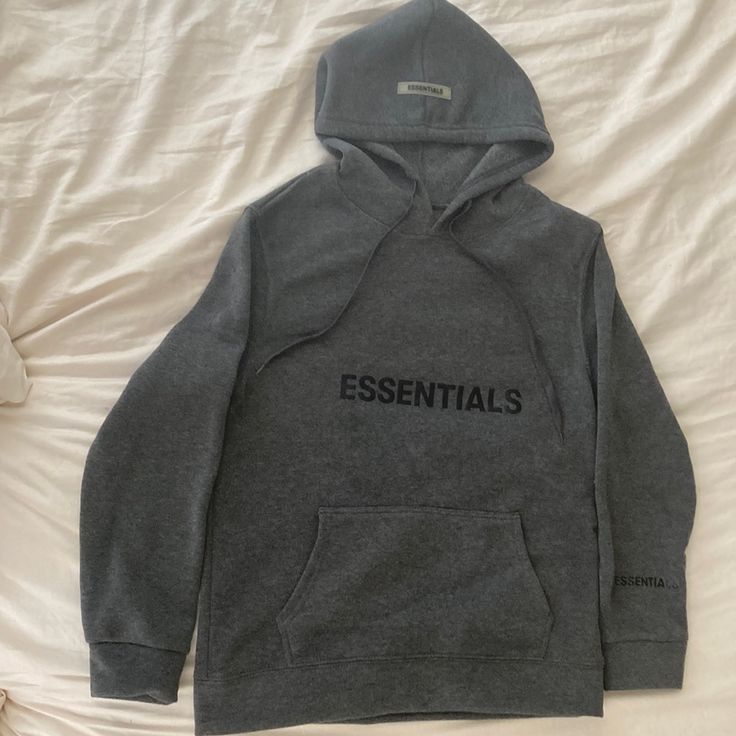 Dark Gray Hoodie With "Essentials" Written On Chest, Bottom Left Sleeve And On Hood. Size L. This Is Not The Essentials Brand, My Daughter Ordered And Missed Window For Return. Never Worn And Not For Anyone Bigger Than A C Cup Size Classic Fall Cotton Hoodie, Gray Hoodie For Everyday Spring Wear, Winter Long Sleeve Sweatshirt, Cotton Hooded Sweatshirt, Cotton Winter Hoodie, Winter Essential Hooded Hoodie, Basic Everyday Hooded Hoodie, Essential Cotton Hoodie For Winter, Basic Everyday Hooded Sweatshirt