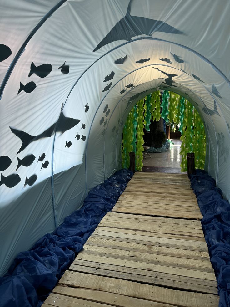 the inside of a large white tent with fish on it