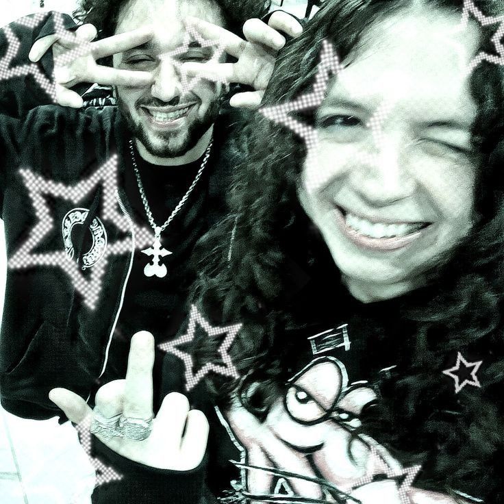 two people making faces with their hands in the shape of stars and crosses on them