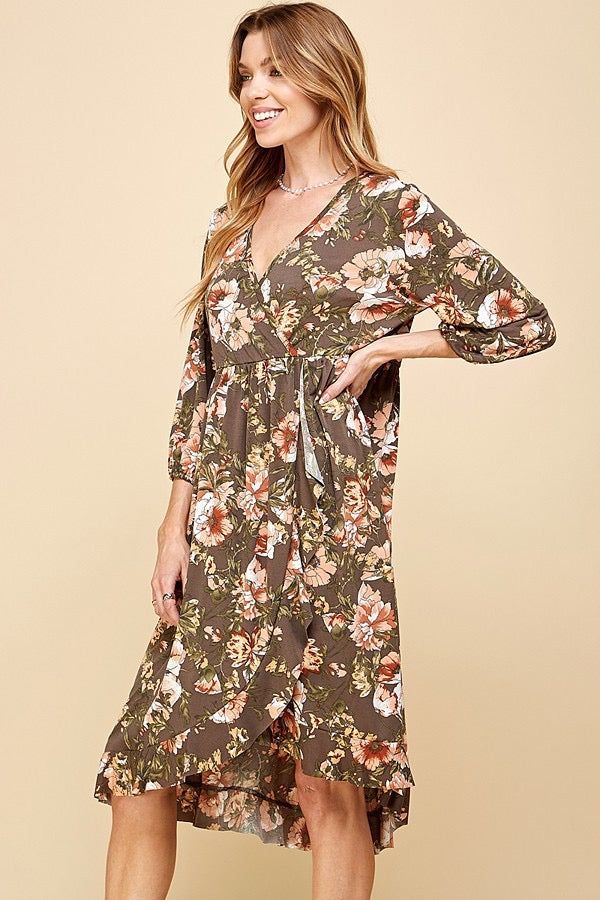 Faux wrap dresses are comfortable, stylish, and worry-free, with a flattering look, and this one is stunning. The gorgeous floral pattern and comfortable material is perfect for Fall. The bottom hemline is ruffled and there is an elastic band around the waist. Style with heels for a wedding. Model is 5'10" and wearing her true size Small. Small: Bust 16", Length 42.5" 95% Polyester, 5% Spandex Spring Flowy Faux Wrap Maxi Dress, Floral Print Wrap Dress For Vacation, Floral Print Wrap Dress For Beach, Floral Wrap Dress For Beach, Floral Print Dress With Surplice Neckline For Brunch, Flowy Faux Wrap Dress For Spring, Flowy Floral Print Wrap Dress For Brunch, Flowy Floral Dress With Surplice Neckline, Spring Floral Print Wrap Dress