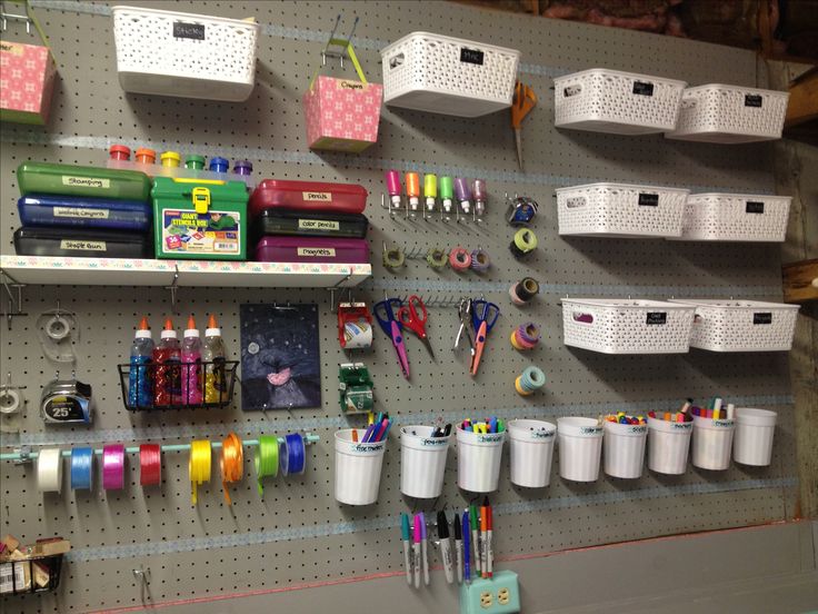 there are many craft supplies hanging on the wall