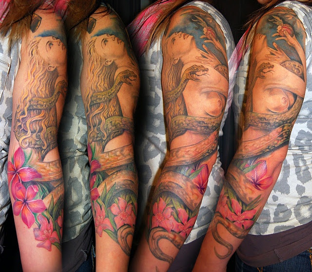 three women with tattoos on their arms, both showing the same color and size as they are