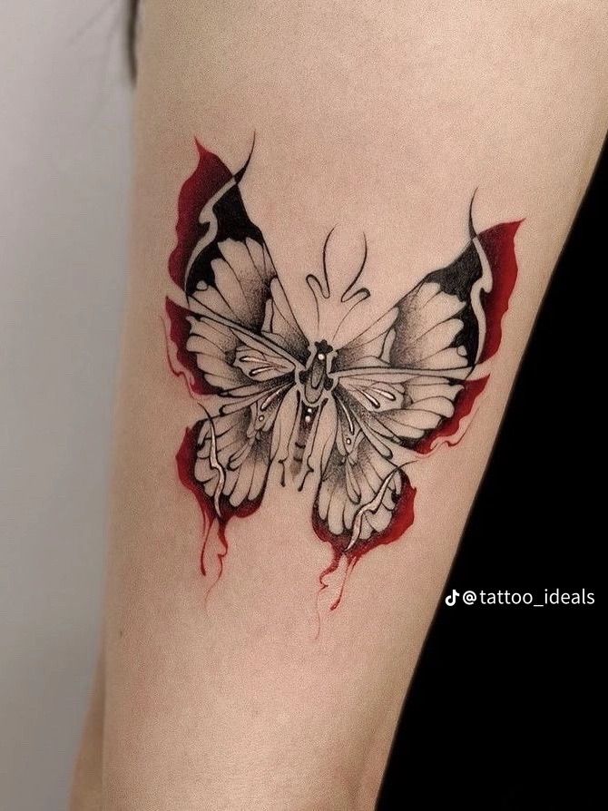 a black and white butterfly tattoo on the right side of the leg, with red streaks around it