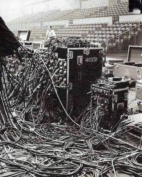 an old black and white photo with many wires in front of the stands at a stadium