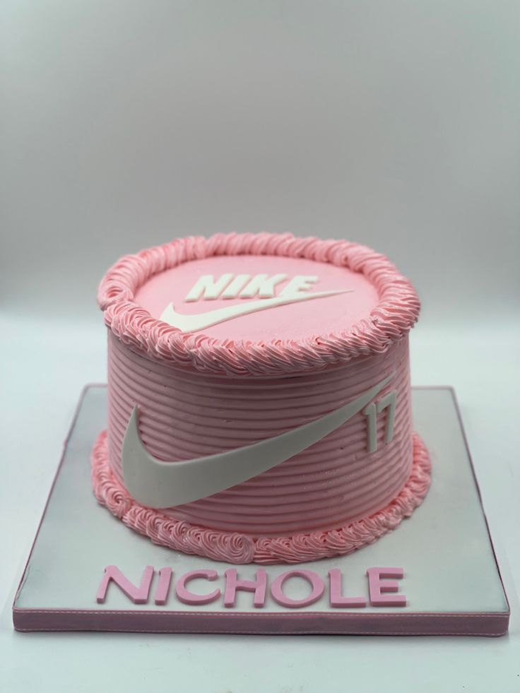 a pink nike cake with the number 11 on it