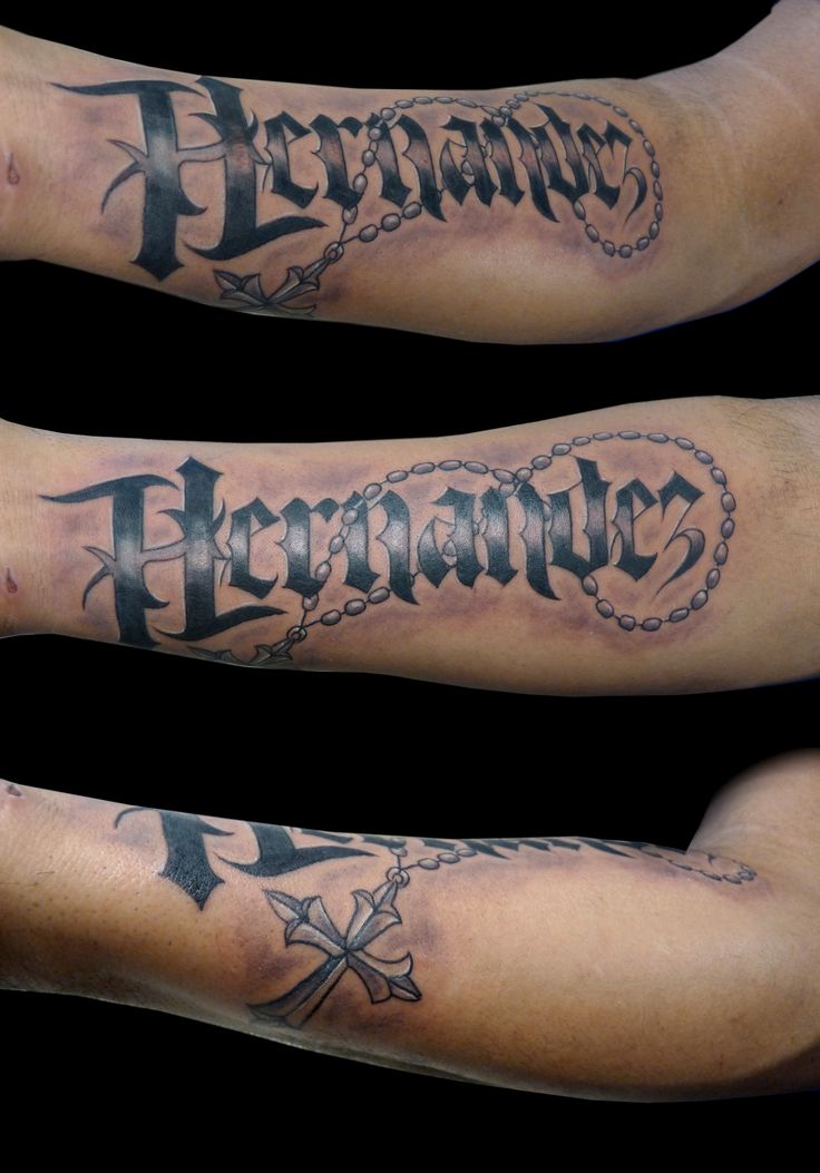 two arm tattoos with words and crosses on them