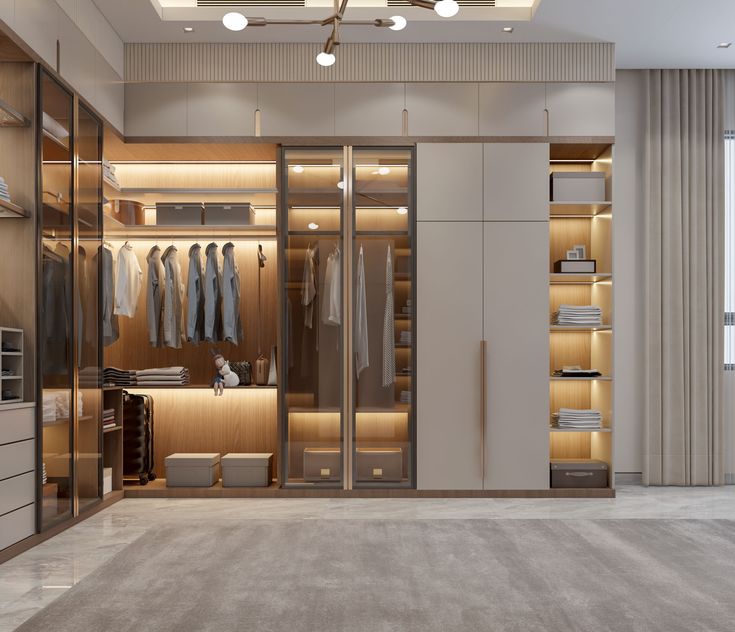 an empty walk in closet with lots of clothes on hangers and lights hanging from the ceiling