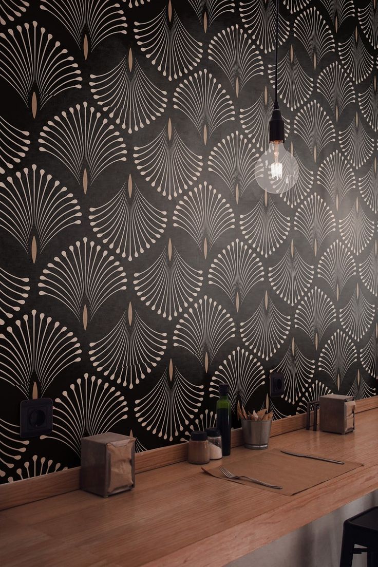 a bar with wooden counter tops and black wallpaper