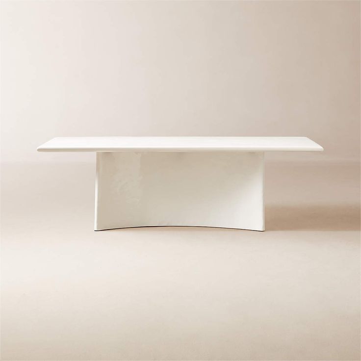 a white table sitting on top of a floor