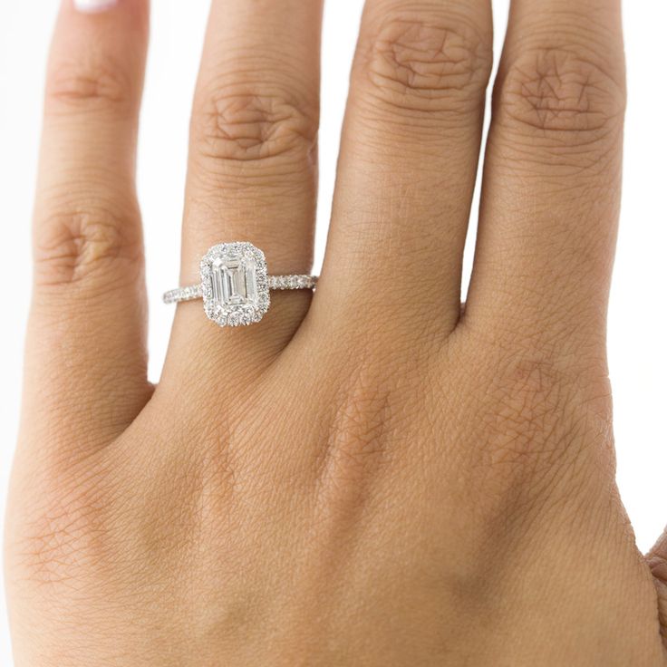 a woman's hand with a diamond ring on it