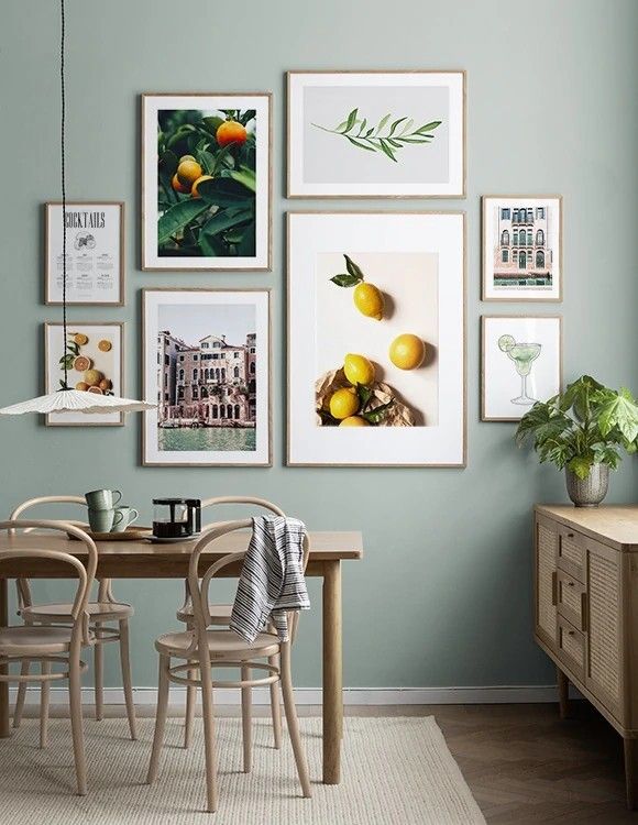 a dining room table with chairs and pictures on the wall above it, along with other furniture