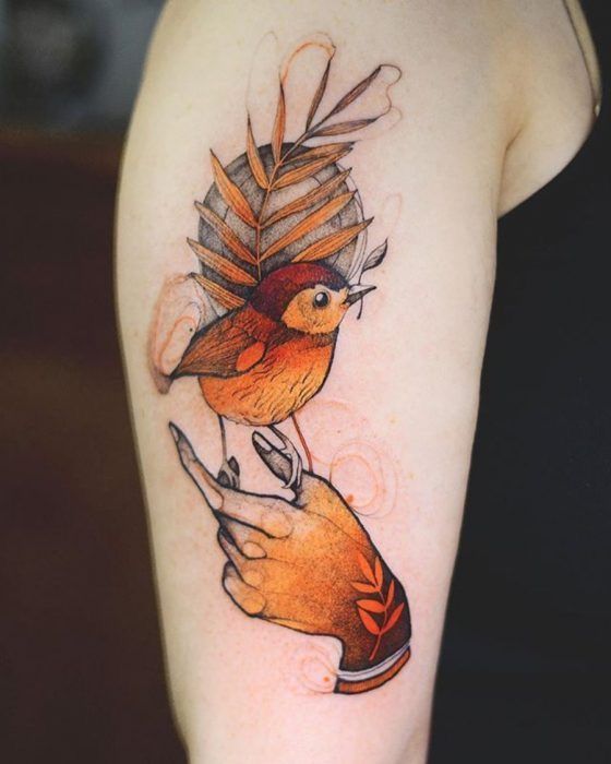 a tattoo with a bird on the arm