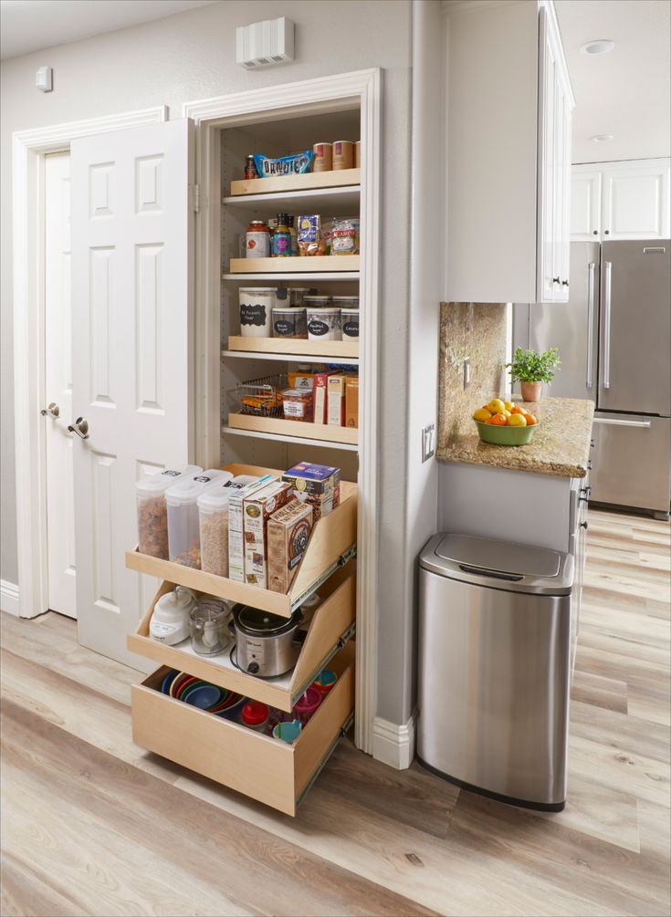 an open pantry in the middle of a kitchen