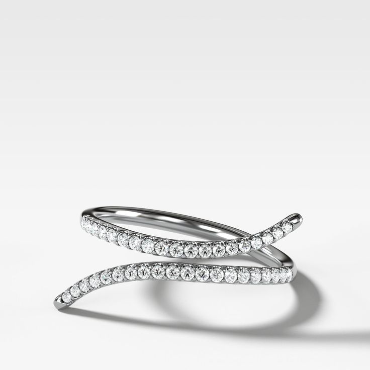 This negative space ring elegantly embraces the finger that wears it with full cut round diamonds in a traditional pave setting. 1.8 mm band 0.15 carats total Timeless Diamond White Stackable Rings With Pave Setting, Modern Twist Cubic Zirconia Diamond White Ring, Formal Stackable Rings With Pave Setting, Luxury Diamond White Stackable Rings With Pave Setting, Elegant Diamond Stackable Rings With Pave Setting, Timeless White Gold Stackable Rings With Pave Setting, Stackable Diamond Rings With Pave Setting, Elegant Bypass Ring With Single Cut Diamonds, Modern Twist Cubic Zirconia Diamond Ring With Brilliant Cut