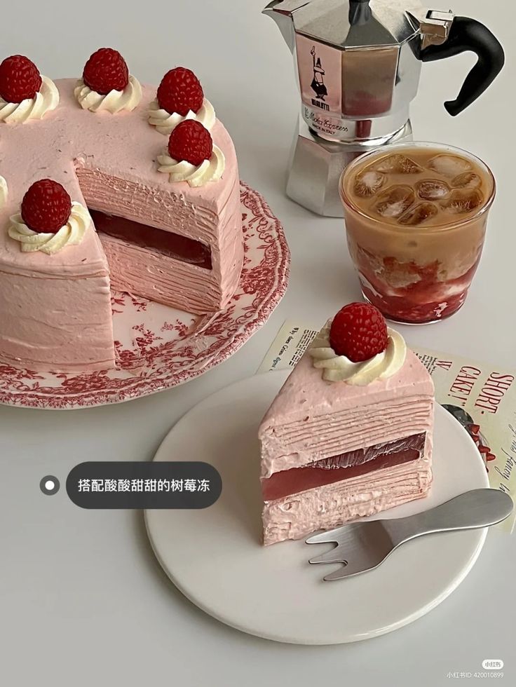 two cakes with raspberries on top, one is pink and the other has white frosting