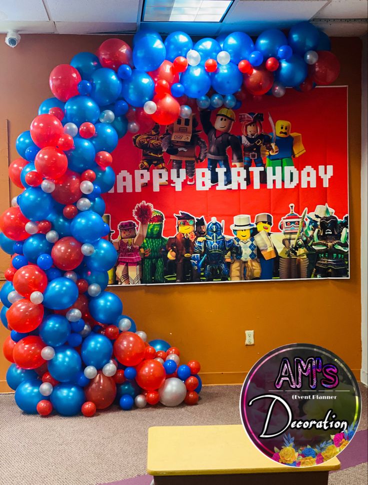 an arch made out of balloons in front of a birthday sign