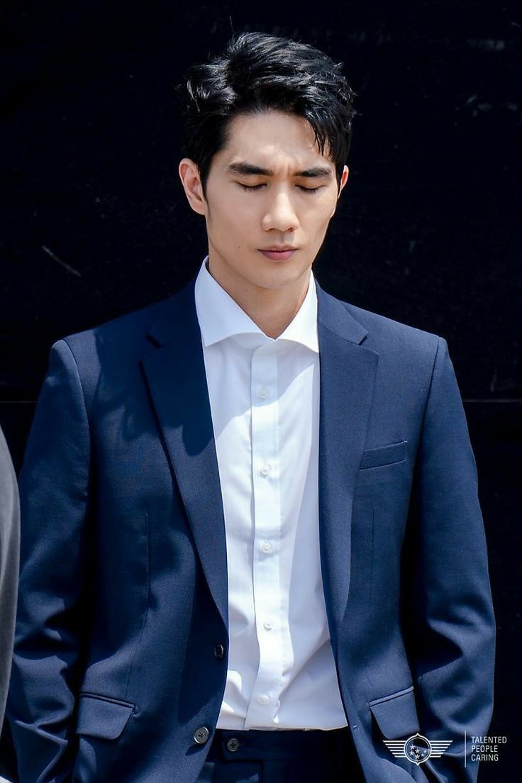 a young man in a suit and white shirt