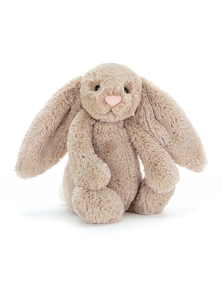 a stuffed rabbit sitting on top of a white surface