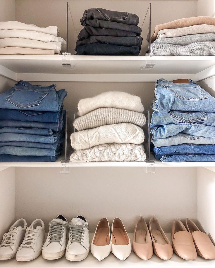 a closet filled with lots of different types of clothes and shoes on top of white shelves