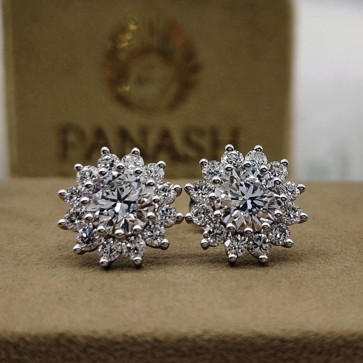 These exquisite moissanite halo stud earrings feature brilliant round cut diamonds surrounded by a shimmering halo, set in luxurious 14k yellow or white gold. Designed with secure push back studs, these earrings are perfect for weddings, special occasions, or adding a touch of elegance to everyday wear. The radiant moissanite and diamond combination ensures a captivating sparkle, while the classic halo design adds timeless sophistication. Ideal for women who appreciate fine jewelry, these earrin Elegant Round Cut Cluster Earrings With Halo Setting, Elegant Round Cut Halo Cluster Earrings, Dazzling Diamond Cluster Earrings With Halo, Dazzling Diamond Halo Cluster Earrings, Dazzling Cluster Earrings With Halo Setting For Formal Events, Classic Cluster Earrings With Halo Setting And Round Cut, Elegant Diamond Cluster Earrings Gia Certified, Halo Design Round Cut Earrings For Anniversary, Dazzling Diamond White Earrings With Halo Setting