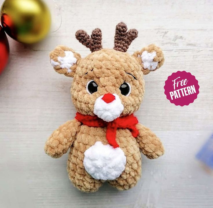 a crocheted stuffed animal with a red nose and antlers on it's head