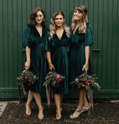 three women in green dresses standing next to each other