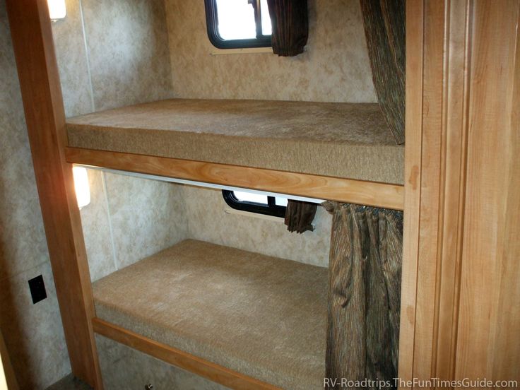 the inside of a travel trailer with bunk beds