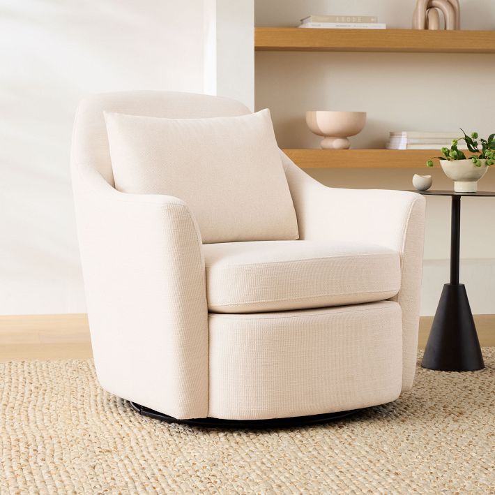 a white chair sitting on top of a rug next to a table