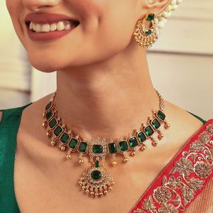 Buy Tarinika's Emerald Shine CZ Choker Set | Indian Jewelry Hand Set Green Kundan Necklace, Green Hand-set Kundan Necklace, Temple Jewelry Style Emerald Necklace For Celebration, Green Kundan Temple Necklace For Party, Temple Style Emerald Necklace For Celebrations, Green Temple Necklace For Party And Festivals, Traditional Green Temple Necklace For Party, Gold Emerald Jewelry Sets For Celebration, Green Kundan Choker Necklace