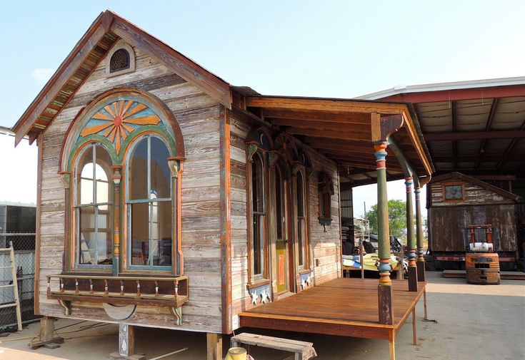 a small wooden building with stained glass windows