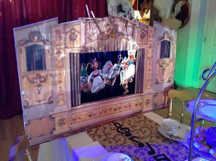 an elaborately decorated entertainment center in the middle of a room with purple lights and curtains