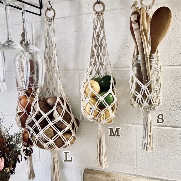 three hanging baskets filled with fruit and vegetables