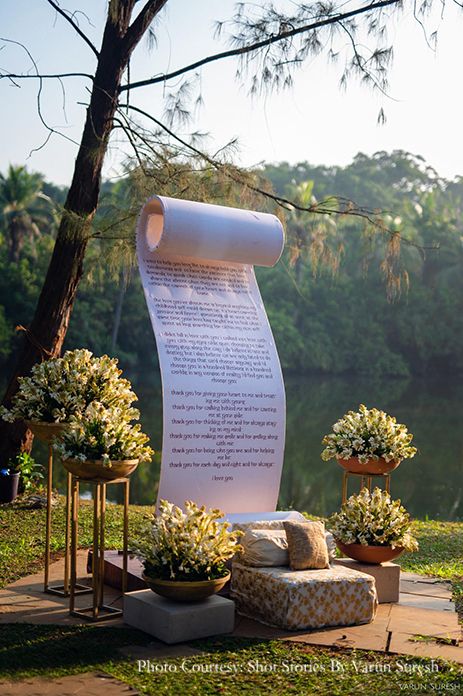 there is a large sheet of paper on the ground next to two planters with flowers in them