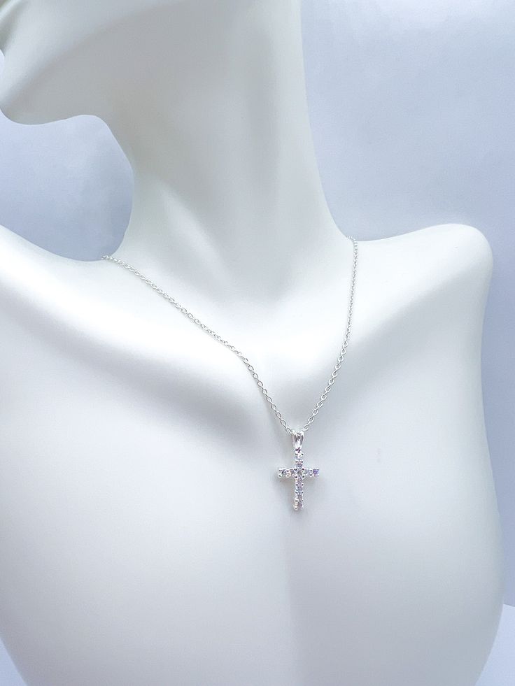 dainty CZ cross necklace on a chain Dainty Crucifix Necklace With Adjustable Chain, White Cross Pendant Necklace With Clavicle Chain, Elegant Cross Necklace With Adjustable Chain, White Cross Necklace With Clavicle Chain, Delicate Sterling Silver Cross Pendant Necklace, Dainty Crucifix Clavicle Chain Necklaces, Dainty Crucifix Cross Necklace With Delicate Chain, Dainty Crucifix Clavicle Chain Necklace, Silver Necklace With Delicate Chain And Cross Pendant