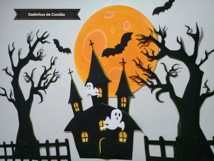 a paper cut out of a house with bats flying over it and the moon in the background