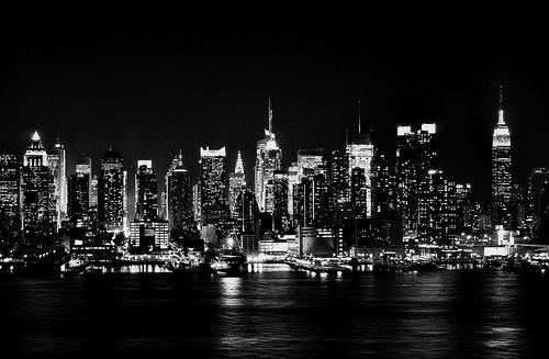 black and white photograph of the city skyline at night