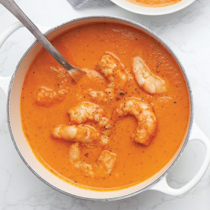 two bowls of soup with shrimp and tomato sauce