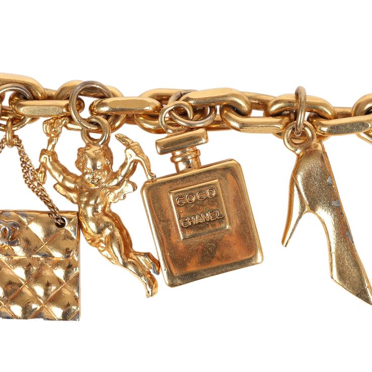 This 80's iconic vintage Chanel lucky charms bracelet features a 24K gold plated chain link with seven of Chanel's "iconic" lucky charms including a clover, shoe, perfume bottle, cherub, Chanel quilted handbag, turtle, and camellia flower. It also has a bar toggle and loop closure.Origin: FranceCondition: Vintage; Very Good - The charm bracelet shows sign of wear with scratching throughout. Some of the charms have chipped/peeled around the corners. There's some discoloration.Measurements: Length Gold Jewelry With Logo Charm For Collectors, Luxury Charm Bracelet With Logo, Luxury Yellow Gold Charm Bracelet With Logo, Vintage Yellow Gold Jewelry With Logo Charm, Elegant Gold-tone Charm Bracelet With Logo, Elegant Gold Charms With Logo, Elegant Gold Charm With Logo, Elegant Gold Logo Charm, Luxury Gold Charms With Removable Details