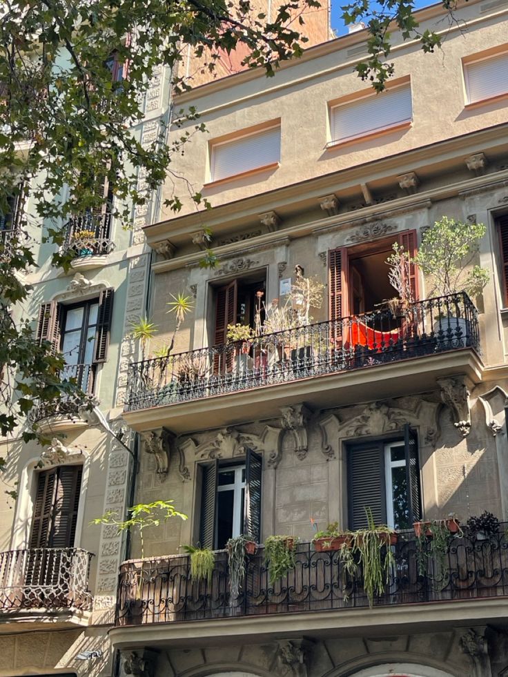 an apartment building with balconies and plants on the balcony