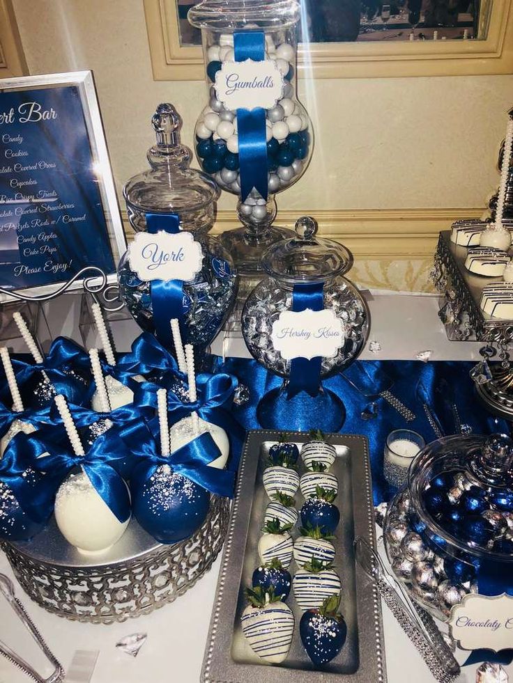 blue and white desserts are on display at a party